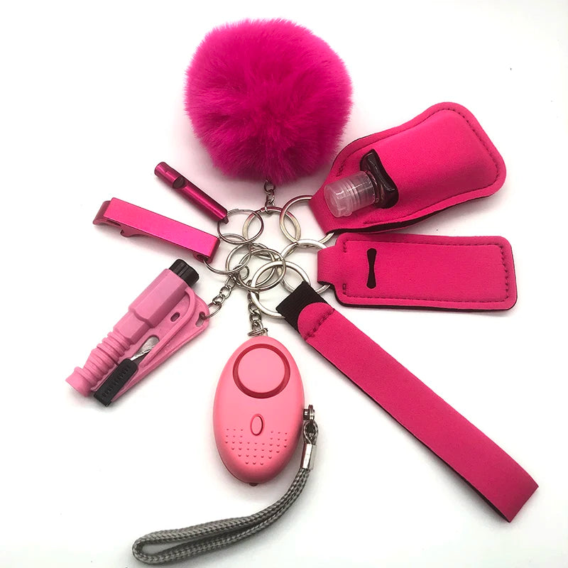 Pink outdoor self-defense keychain accessories set including fluffy pom-pom, safety alarm device, whistle, window breaker tool, and hand sanitizer holder. Loving EasyLife, Safety Keychain, AVADA - Best Sellers