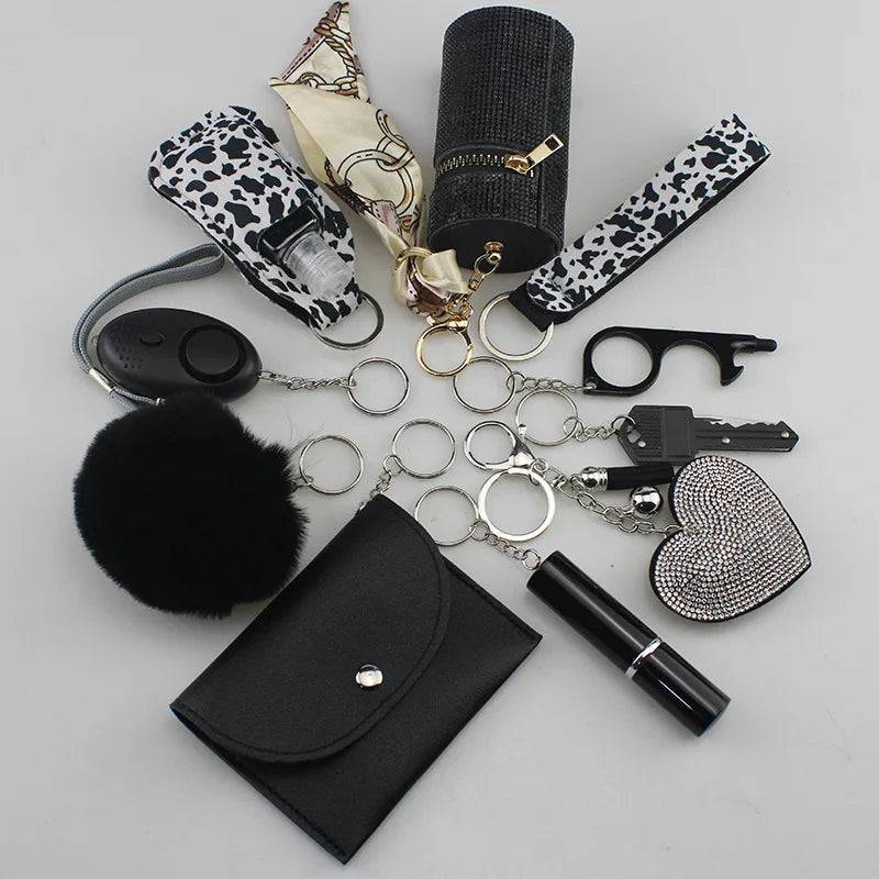 SafetyKey set including a personal alarm, cardholder, wrist strap, lipstick holder, perfume bottles, organizer pouch, fluffy pompon, and whistle.