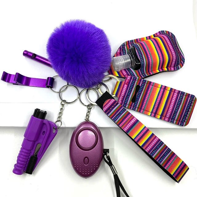 A set of eight self-defense accessories in high-quality brass, featuring a purple alarm, pom-pom, safety tool, and colorful striped holders.