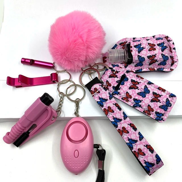 Set of eight self-defense keychains, including a pink fluffy pom-pom, a pink whistle, a pink alarm, a pink safety tool, and patterned butterfly accessories, made from high-quality brass material.