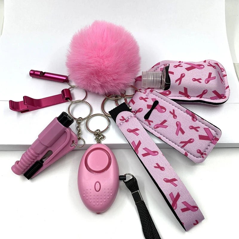 A set of eight pink self-defense keychain accessories, including a pom-pom, whistle, hand sanitizer holder, alarm, and other safety tools, designed with a stylish and elegant appearance featuring pink ribbons.