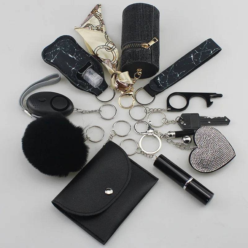 Set of personal safety items including a loud siren alarm, cardholder, wrist strap, lipstick holder, perfume containers, organizer pouch, fluffy pompom, and a whistle, all compact and designed for keychain attachment.